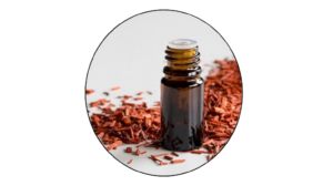 A bottle of Sandalwood Oil with red rose petals, perfect for aromatherapy and relaxation.